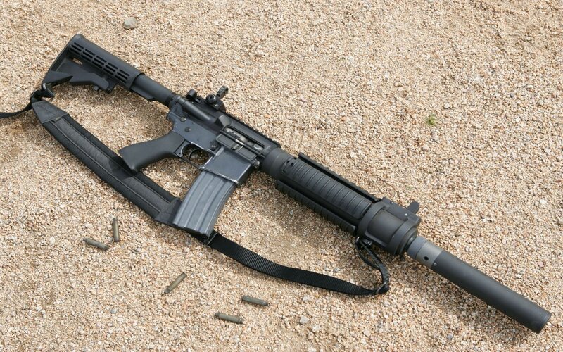 black rifle on gravel