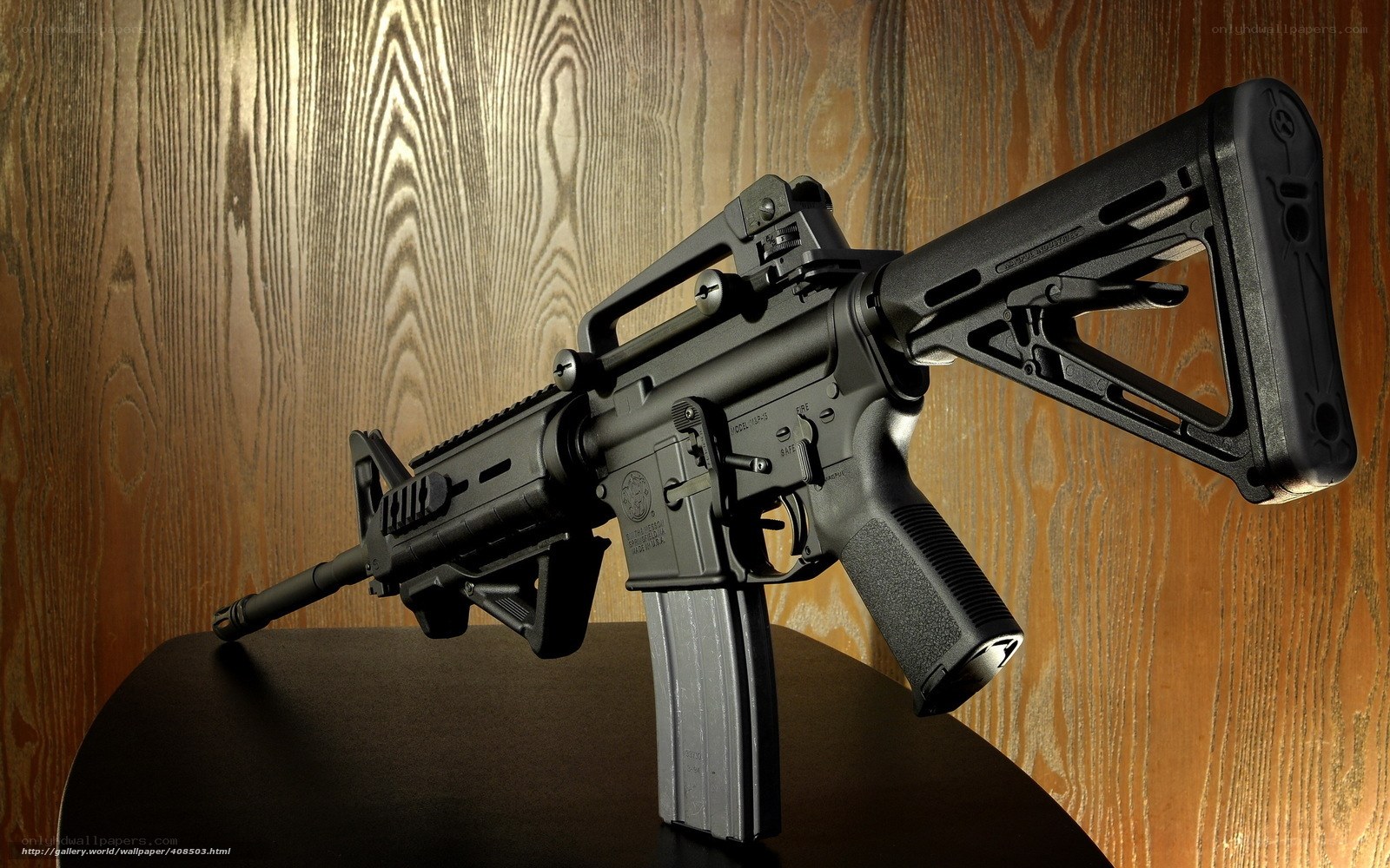 black rifle on wooden surface