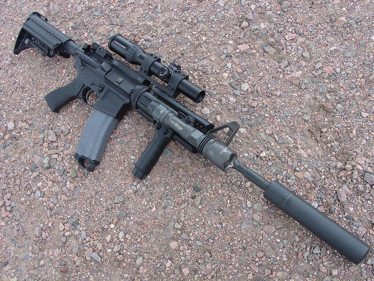 black rifle with scope and suppressor