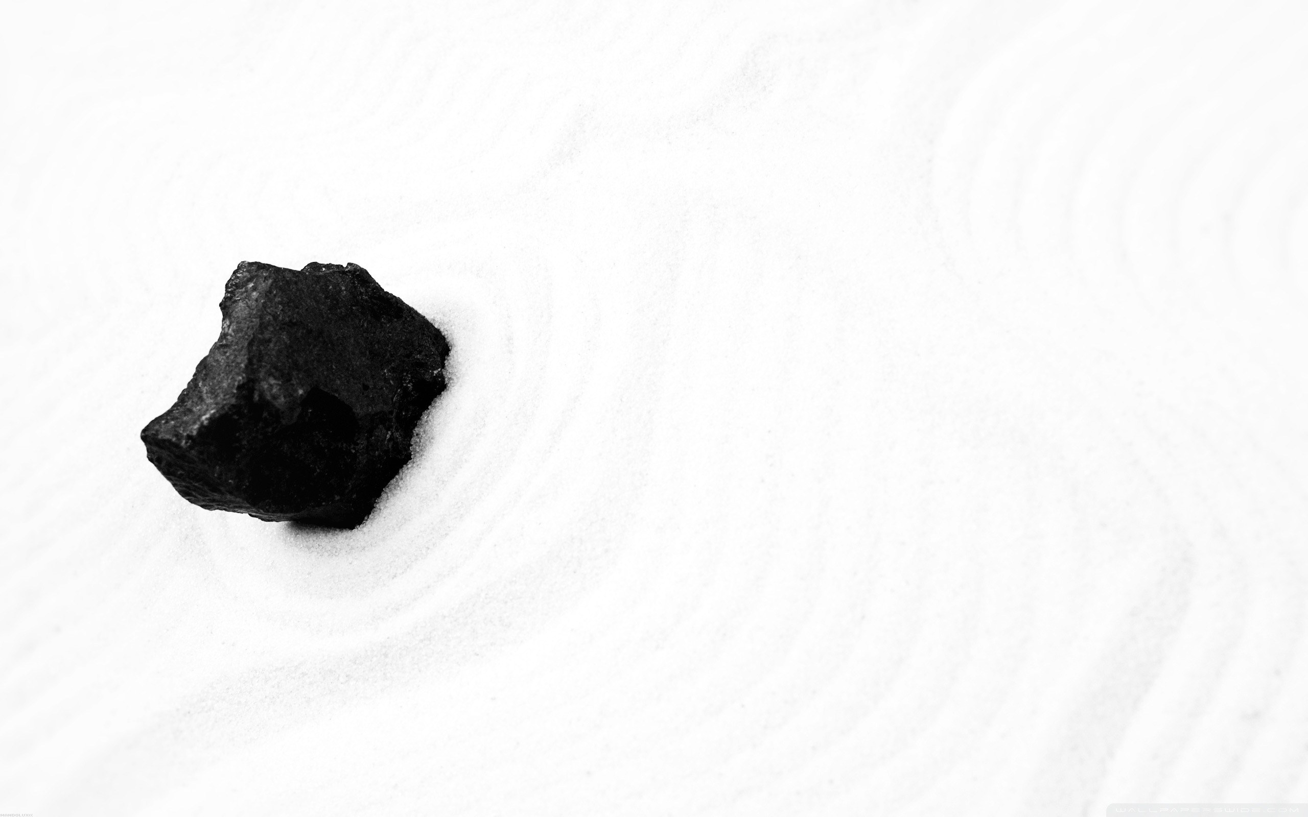 black rock on white sand