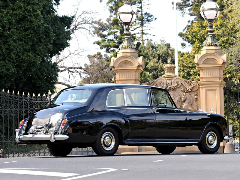 Black Rolls-Royce at ornate gate