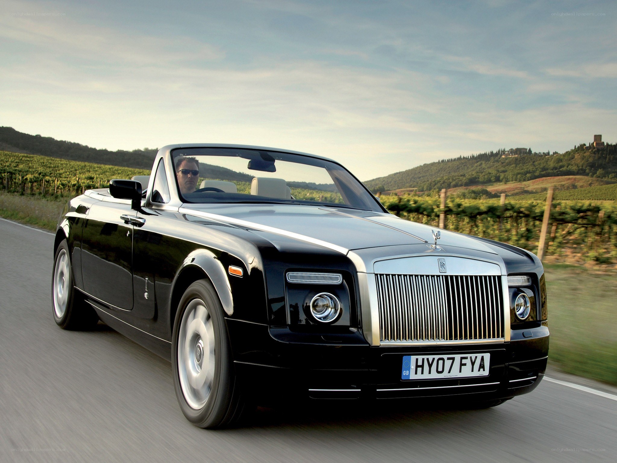 Black Rolls-Royce convertible on road