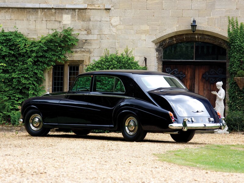 Black Rolls-Royce in front of stone building
