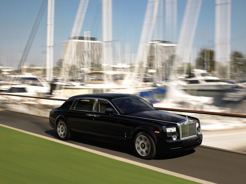 Black Rolls-Royce on a coastal road