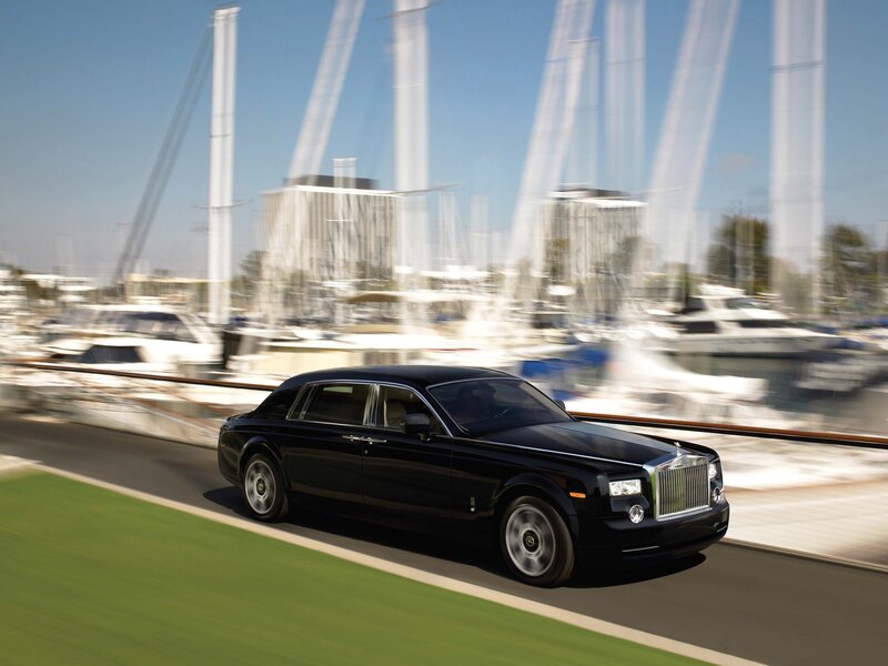 Black Rolls-Royce on a marina road
