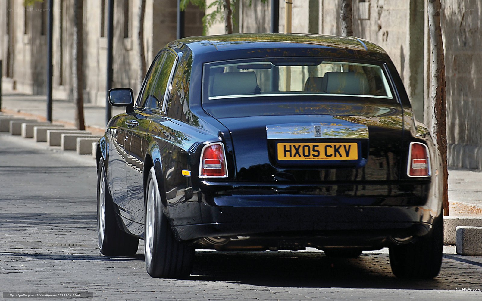 Black Rolls-Royce on cobblestone street