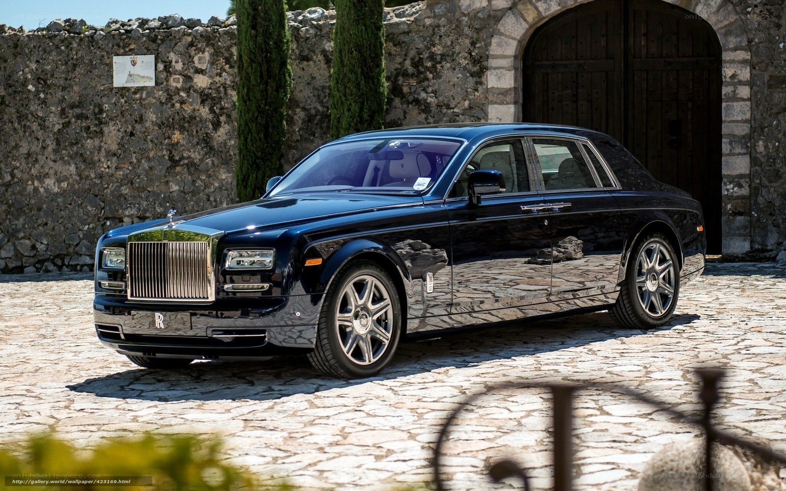 Black Rolls-Royce on cobblestone