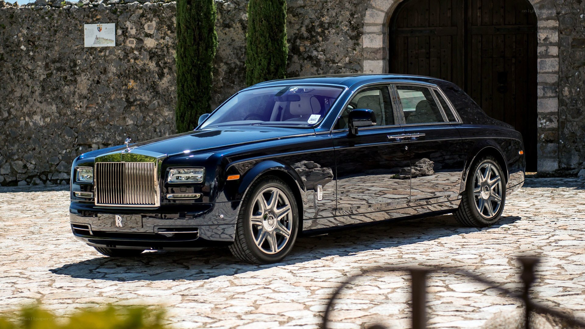 Black Rolls-Royce on cobblestones