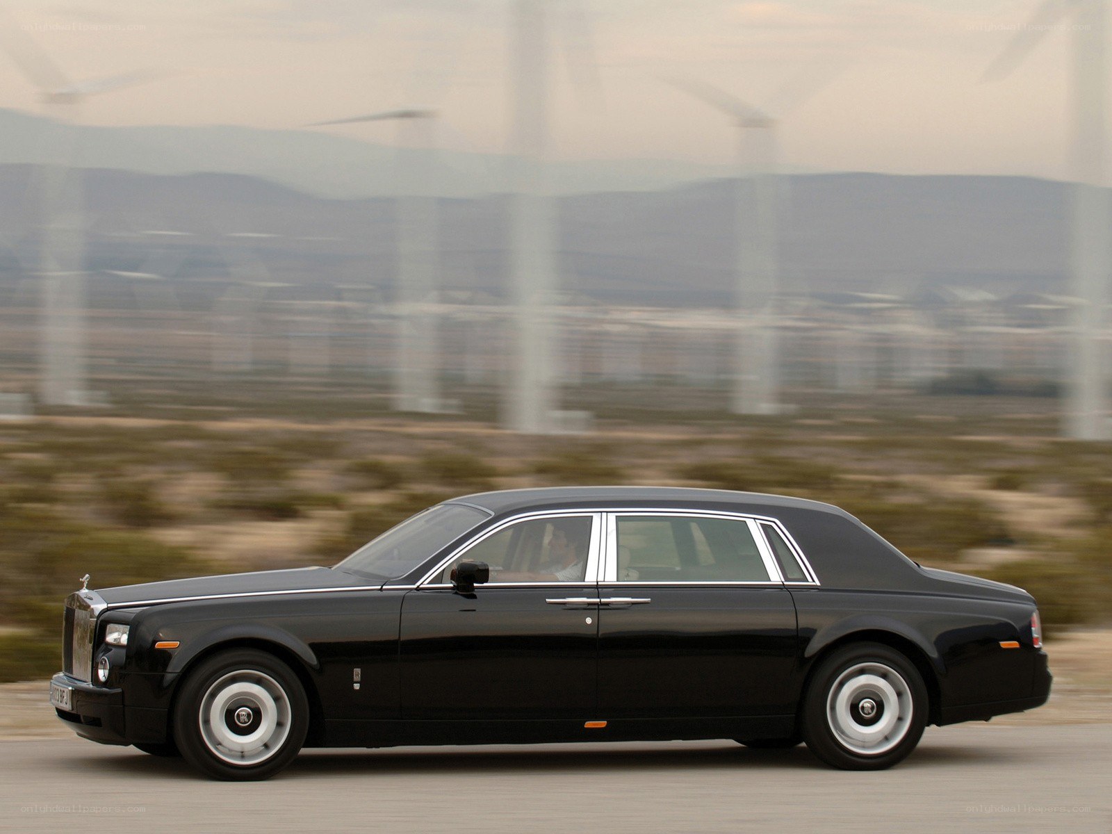 Black Rolls-Royce on desert road