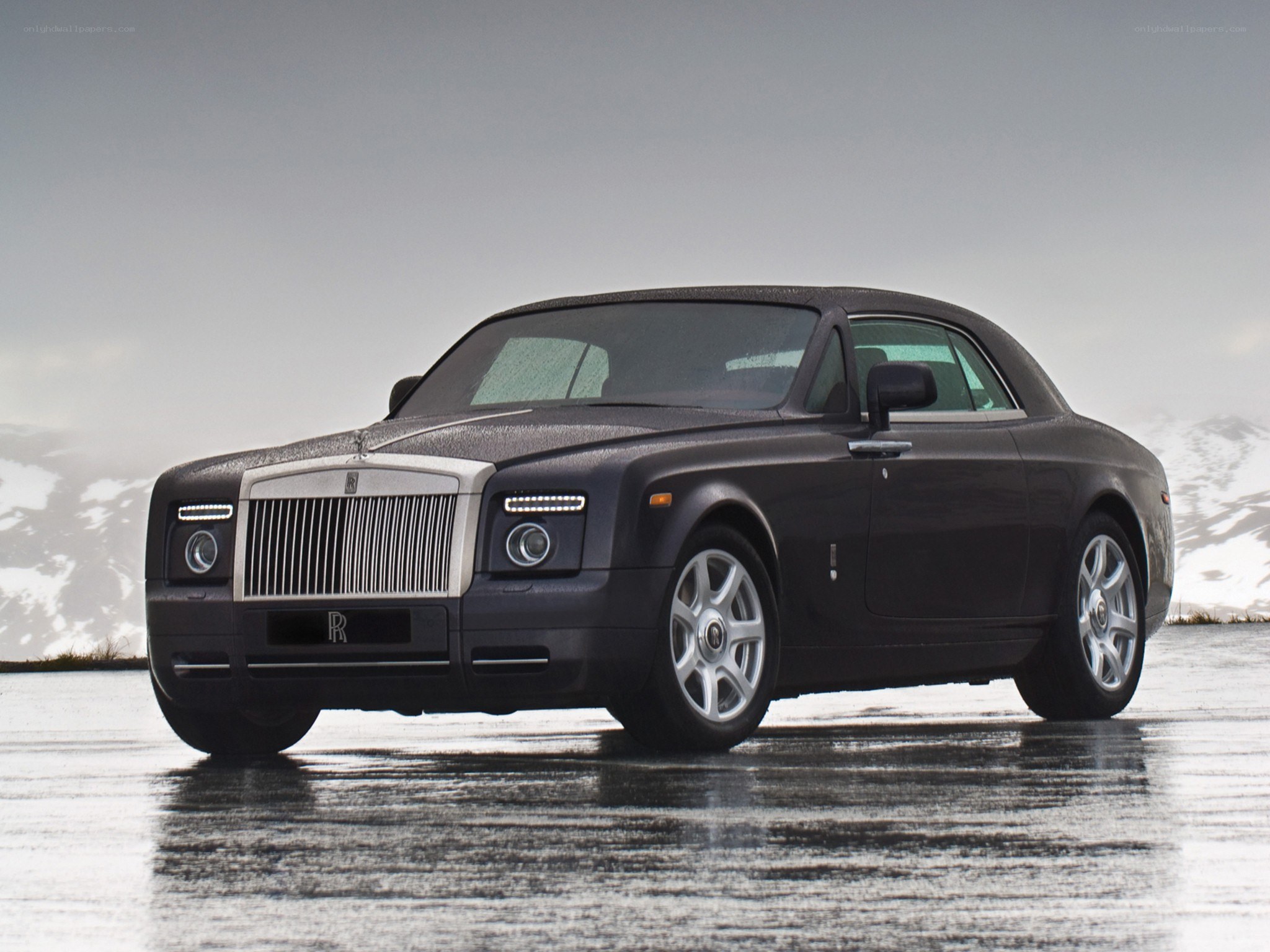 Black Rolls-Royce on wet road