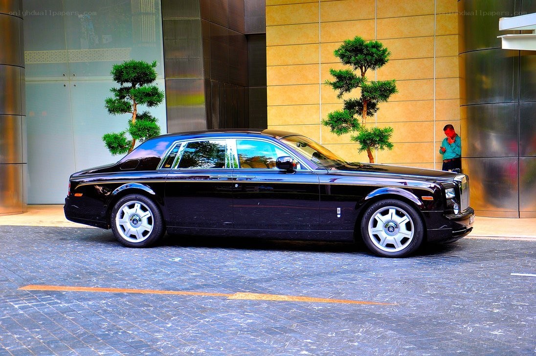 Black Rolls-Royce parked outside building