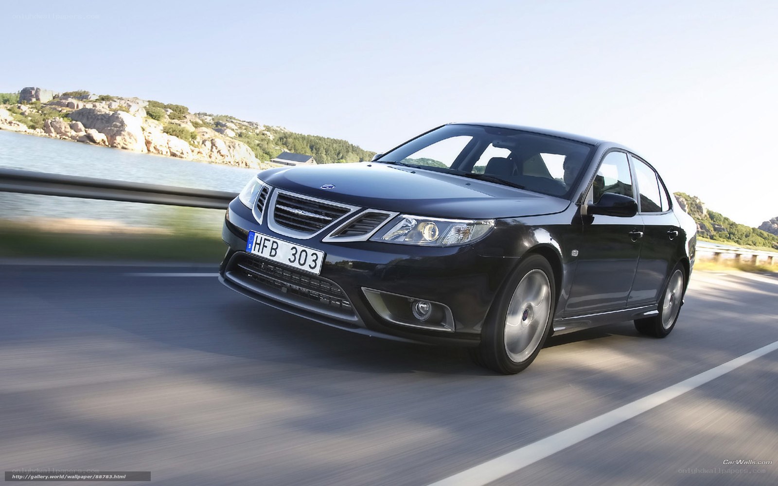 Black Saab on coastal road