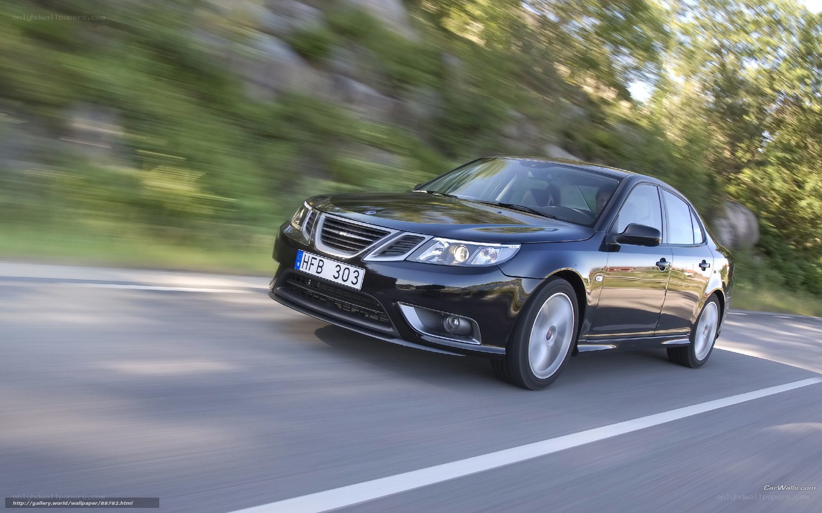 black saab sedan in motion