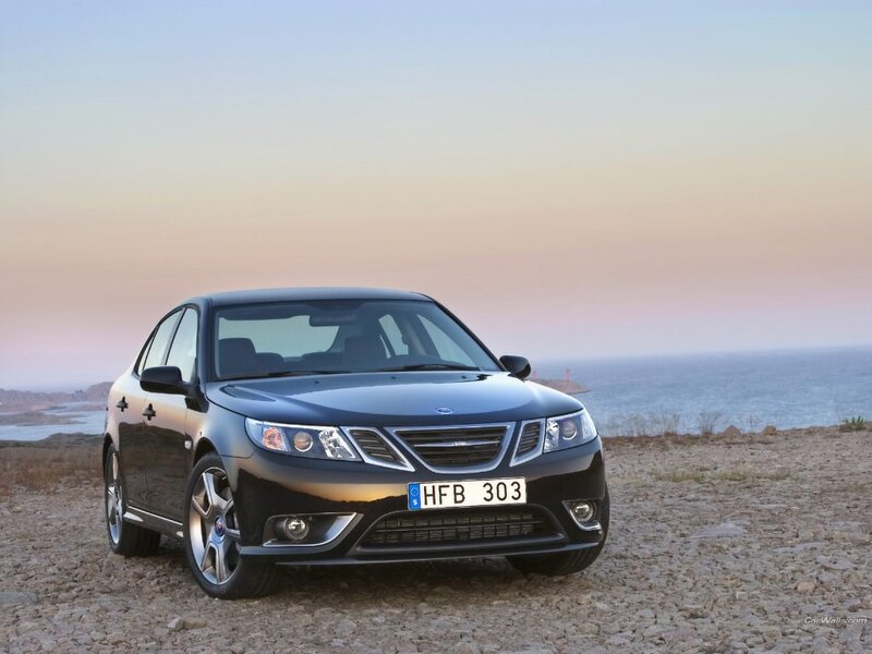 Black Saab sedan on a coastal cliff