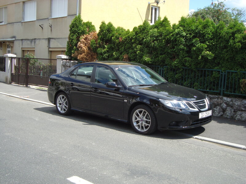Black Saab sedan parked on street