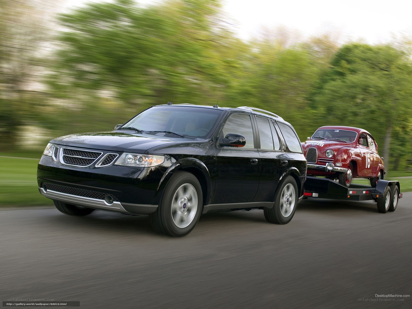 black saab towing vintage car