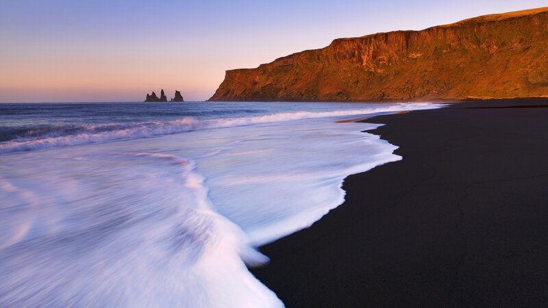 Black sand beach at sunset