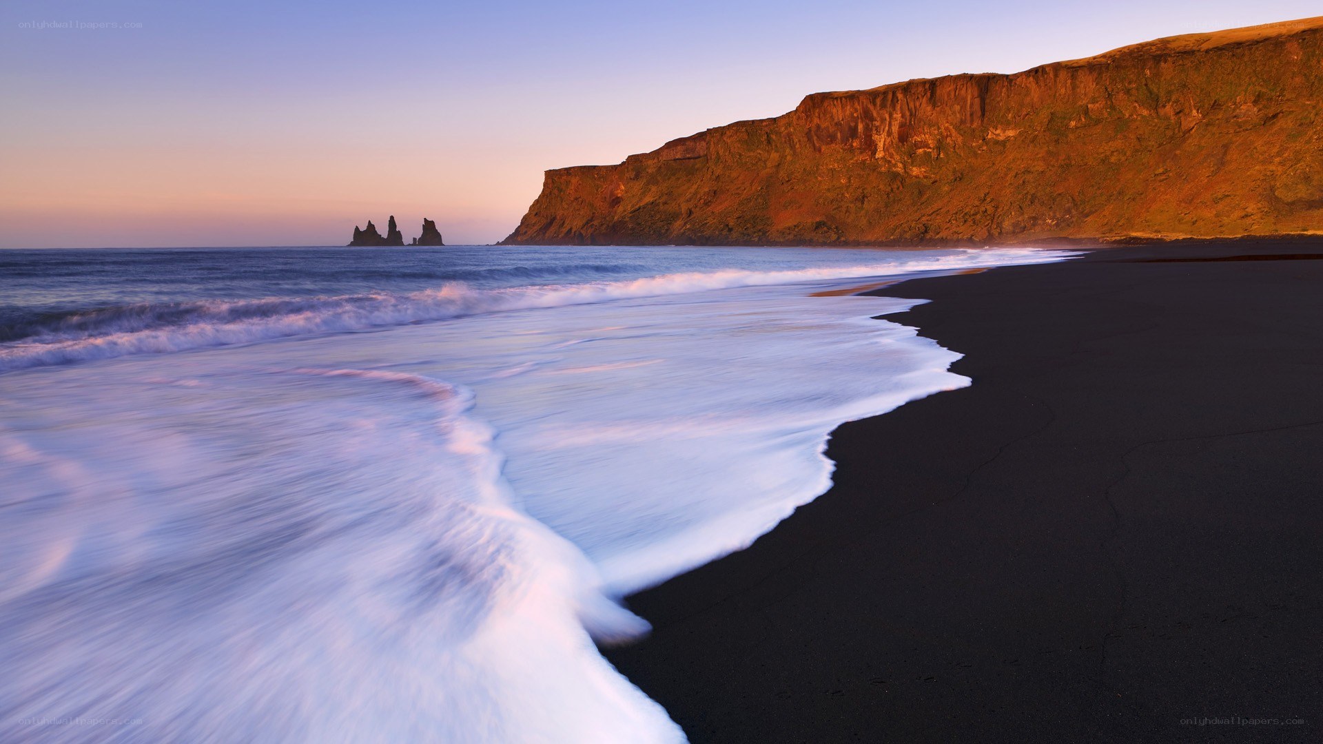 Black sand beach at sunset