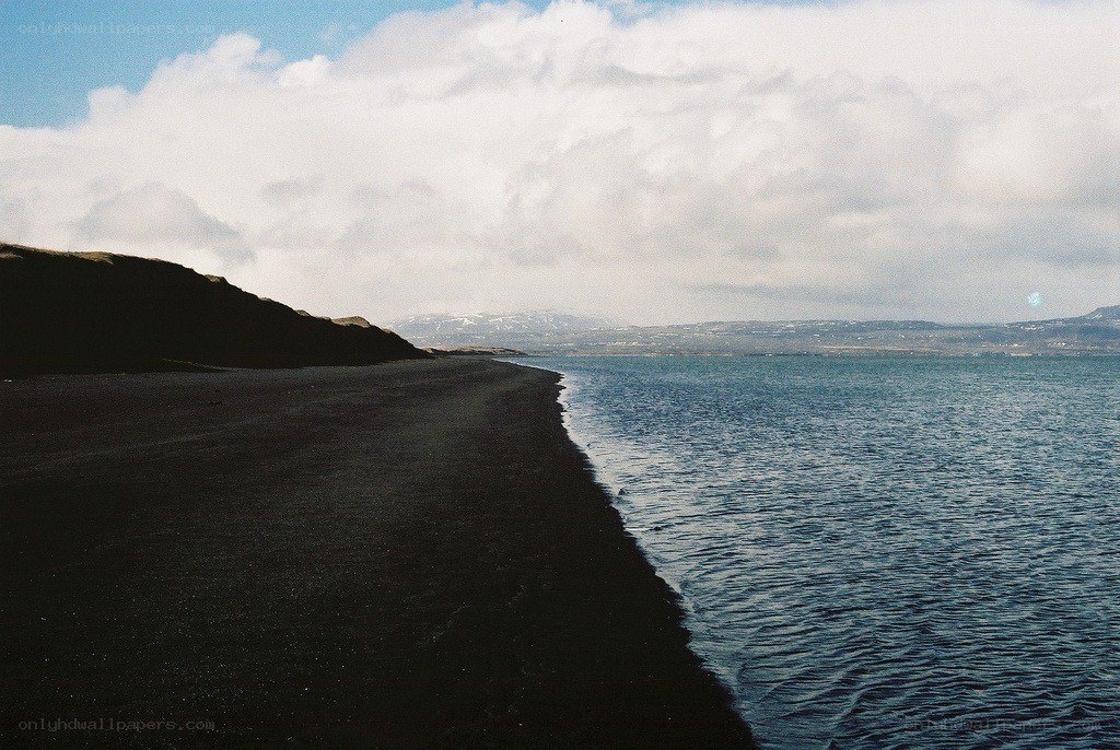 black sand beach with calm sea