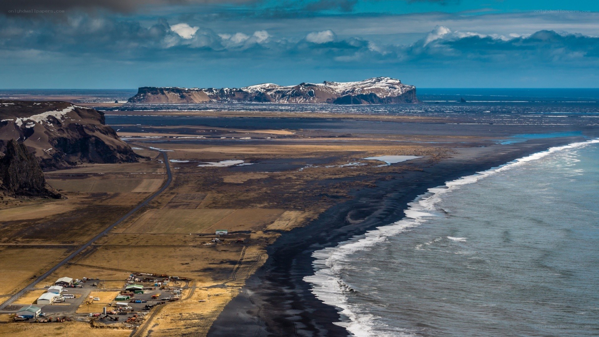 Black sand beach with distant island
