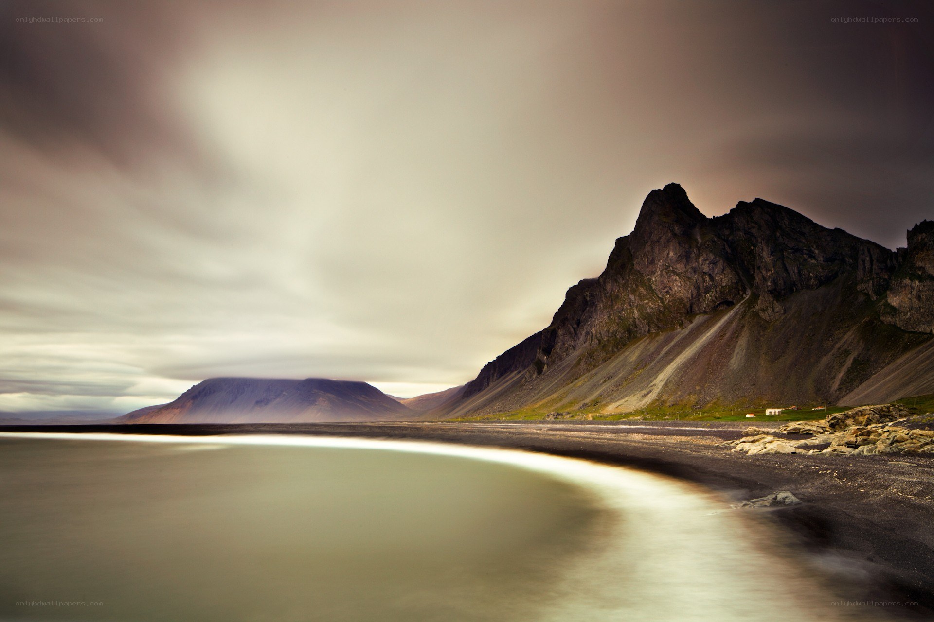 Black sand beach with mountain