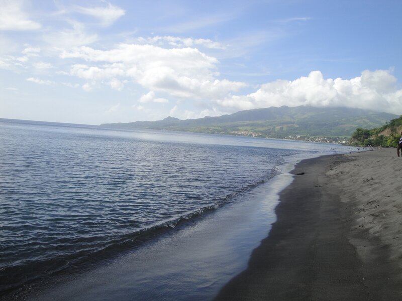 black sand beach with mountains