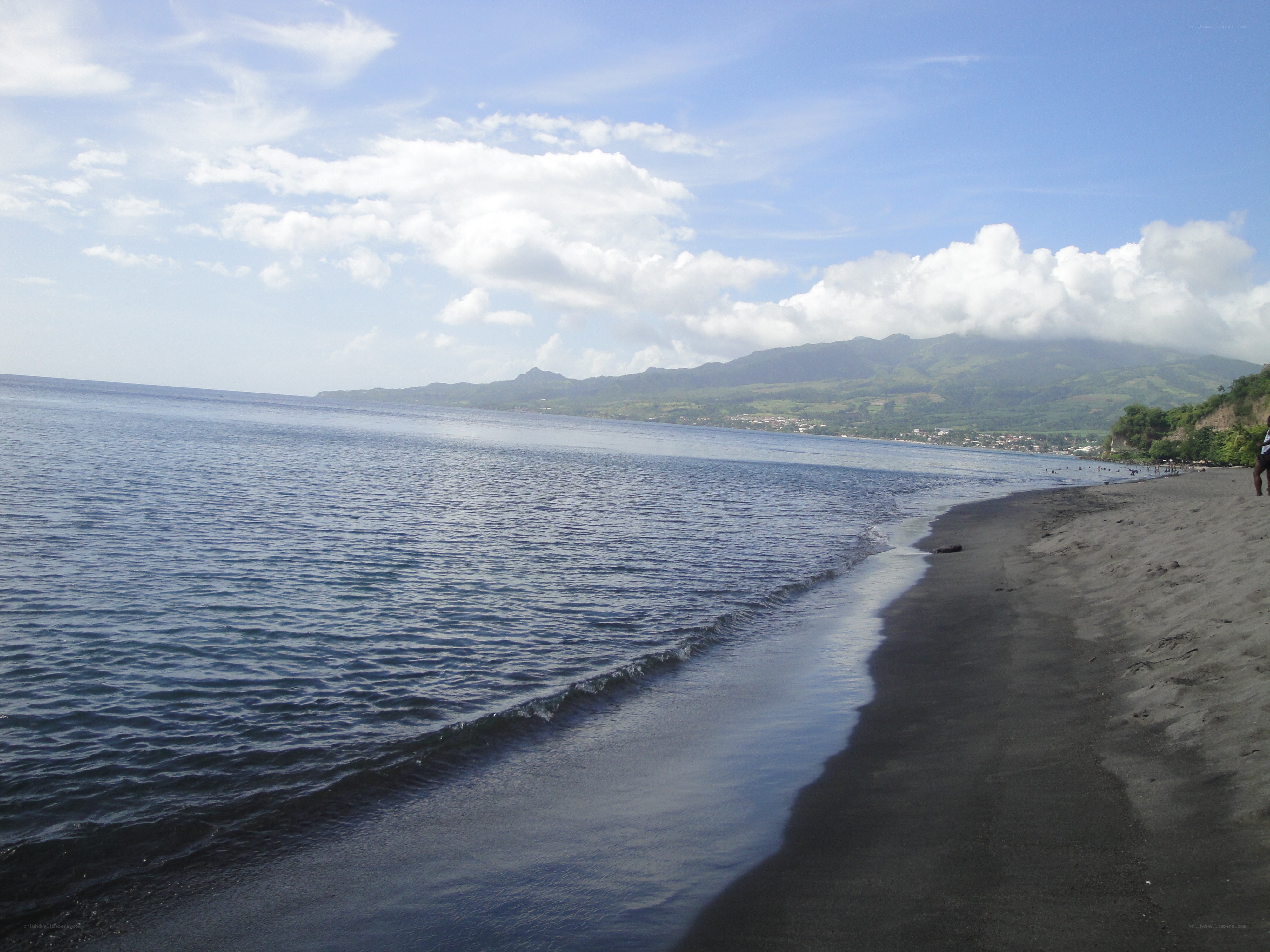 black sand beach with mountains