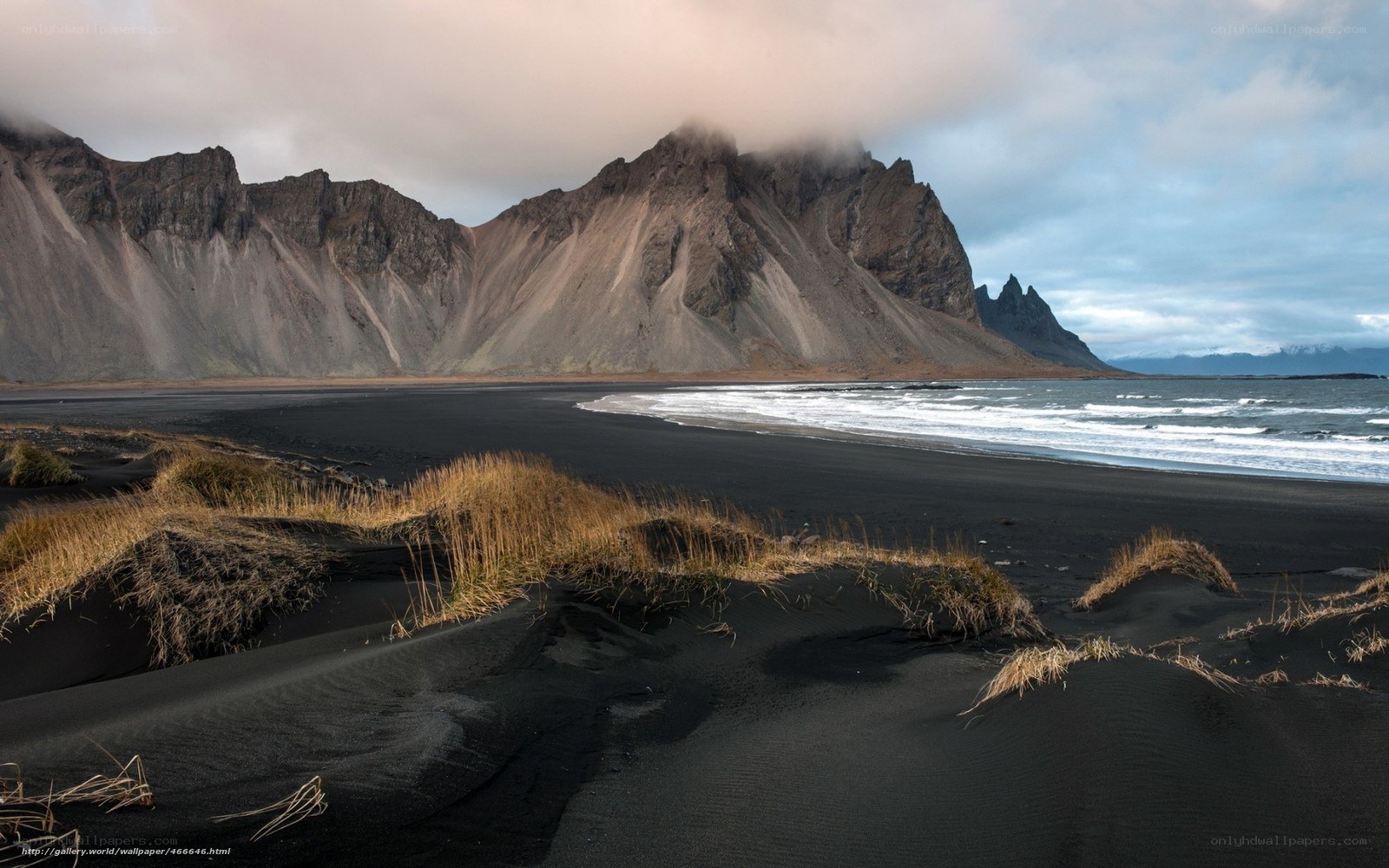 Black sand beach with mountains