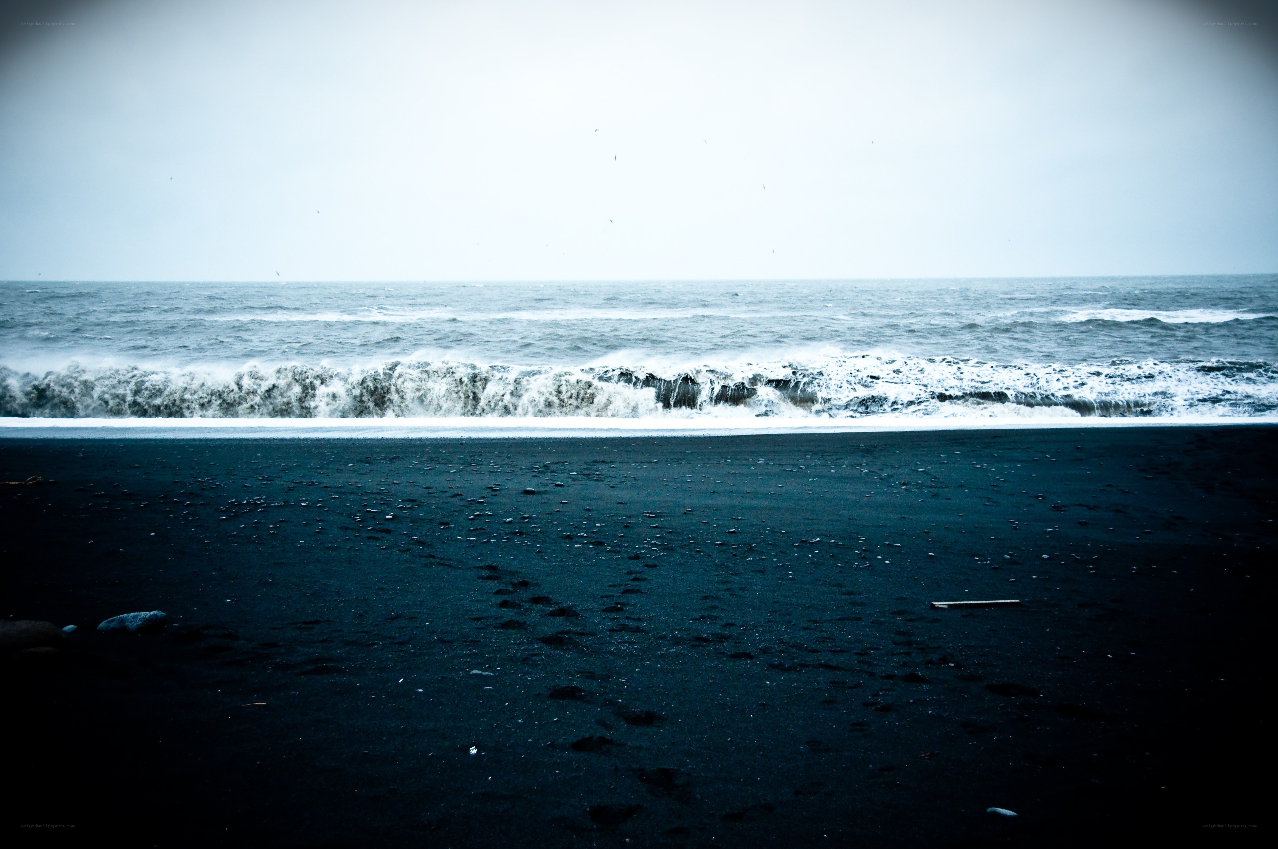 black sand beach with ocean waves
