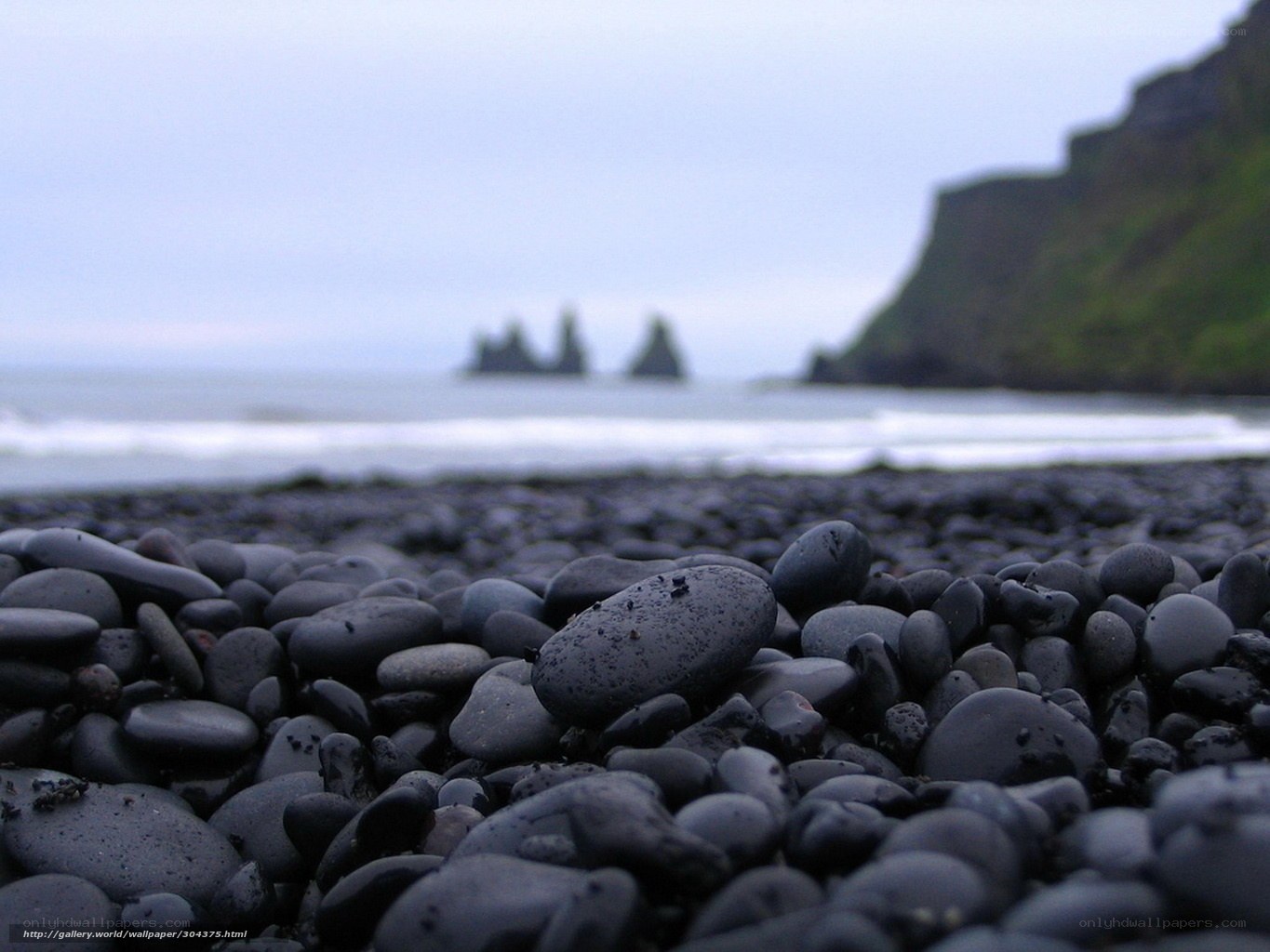 black sand beach with sea stacks