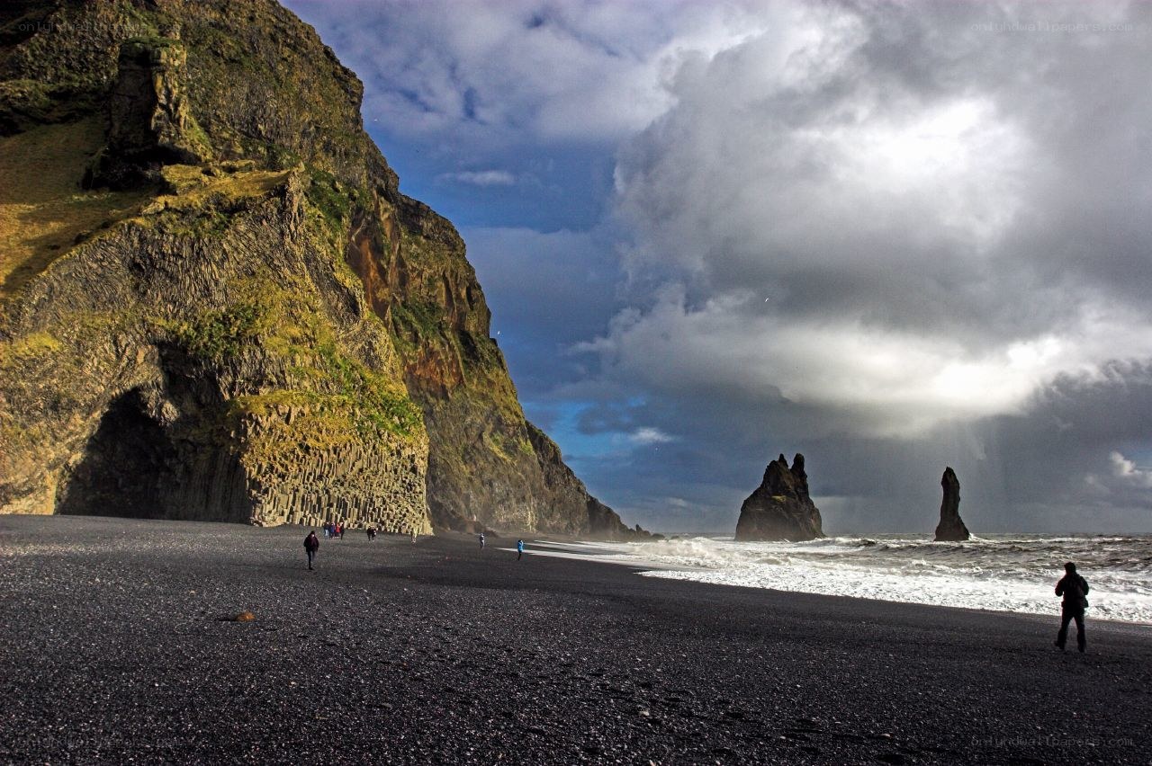 Black sand beach with sea stacks