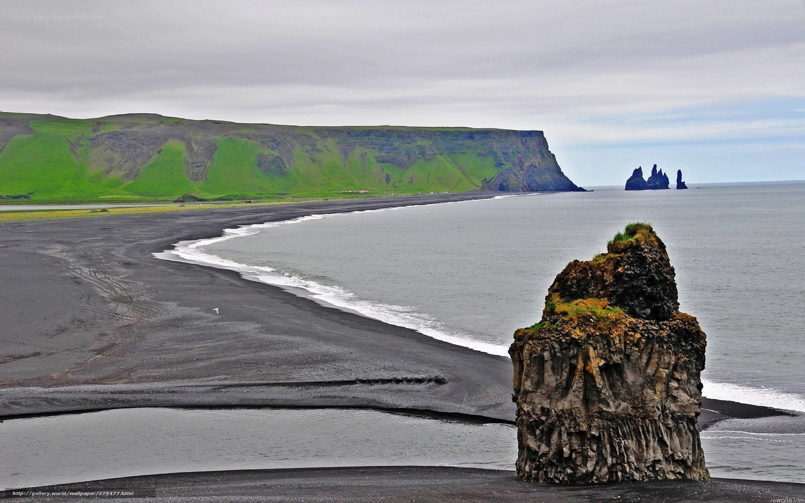 Black sand beach with sea stacks