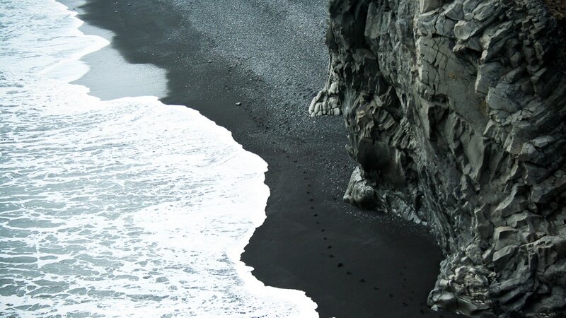Black sand beach with waves
