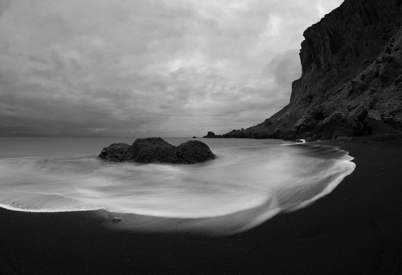 Black sand beach with waves