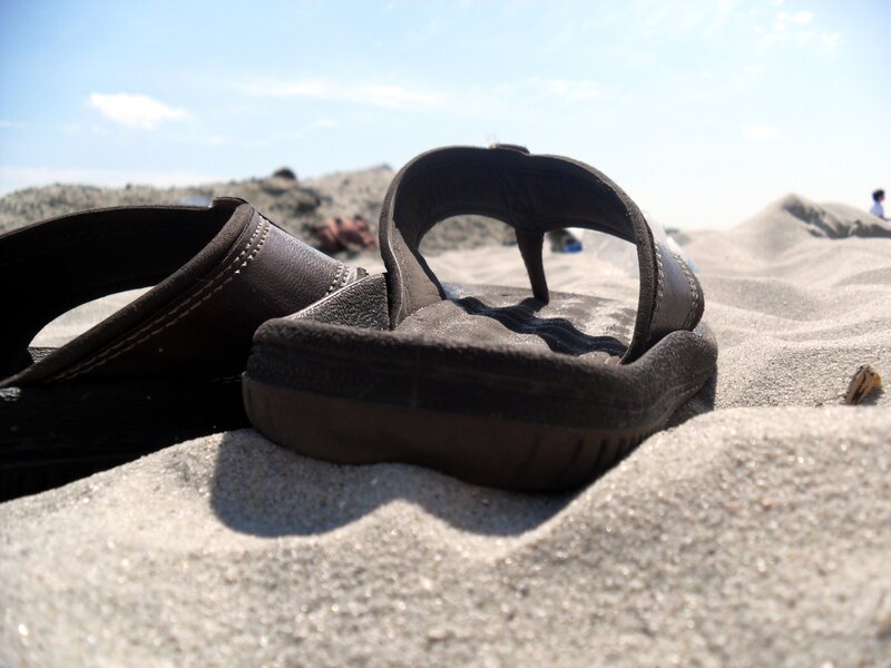 Black Sandals on Sand