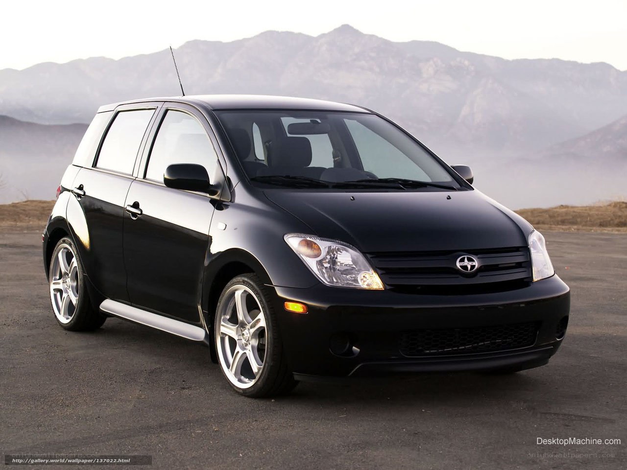 Black Scion xA parked on asphalt