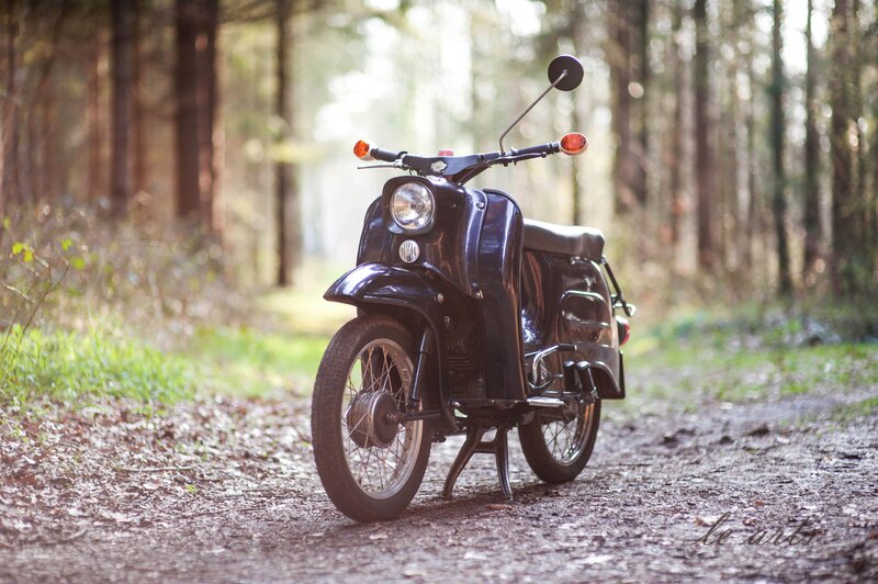 Black Scooter in Forest