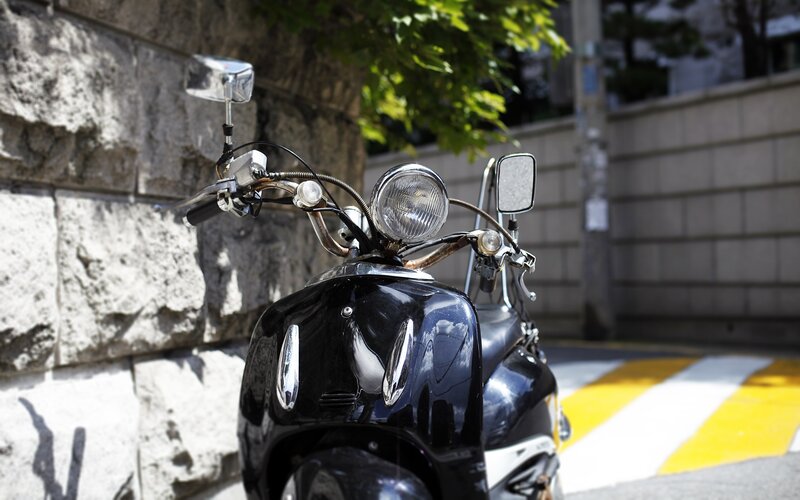 Black scooter on a city street