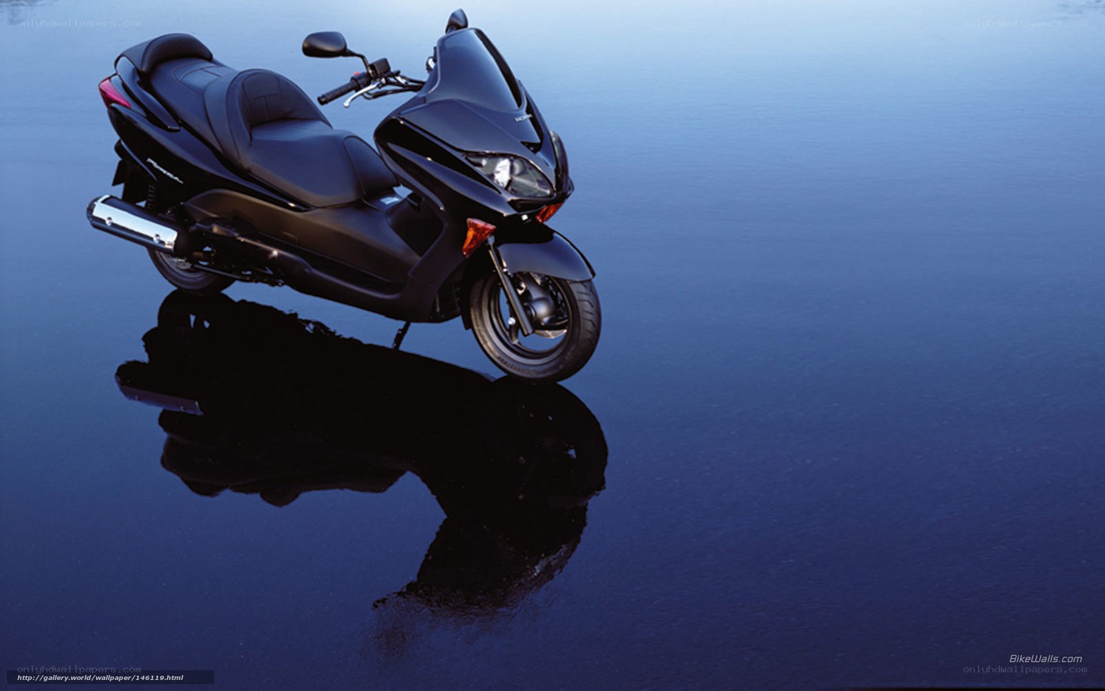 Black scooter on reflective surface