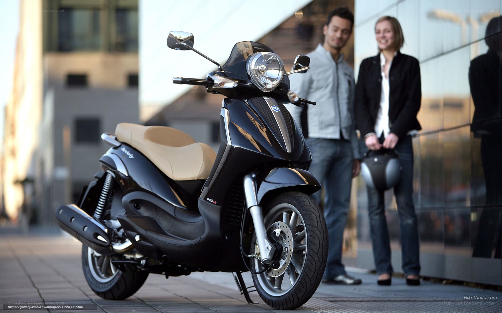 Black scooter with couple in background