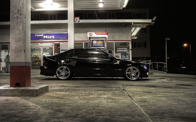 Black sedan at gas station