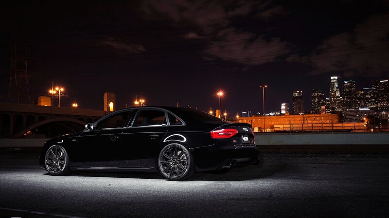 Black sedan at night in city
