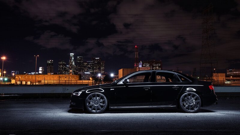 Black sedan at night in city