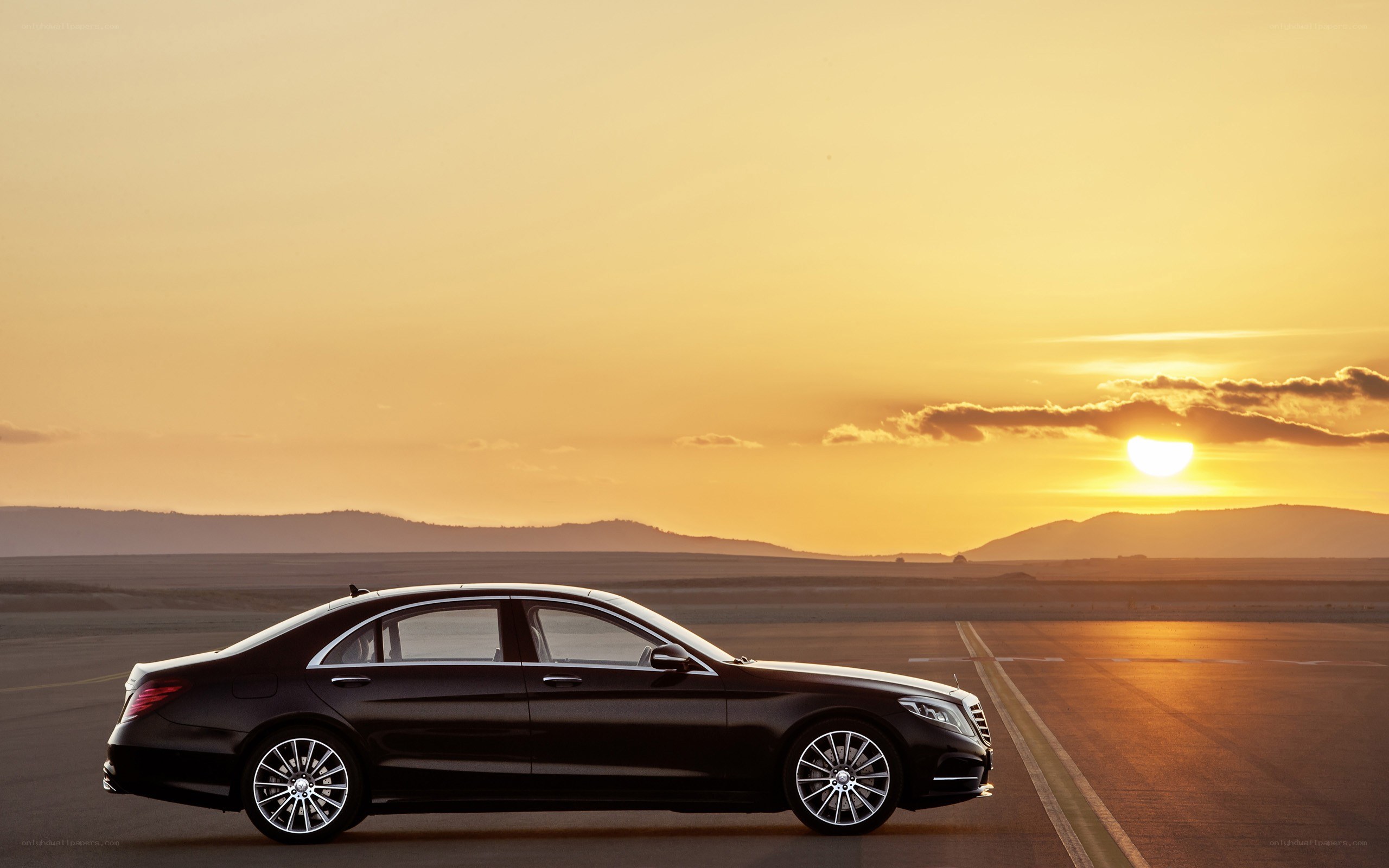 Black sedan at sunset