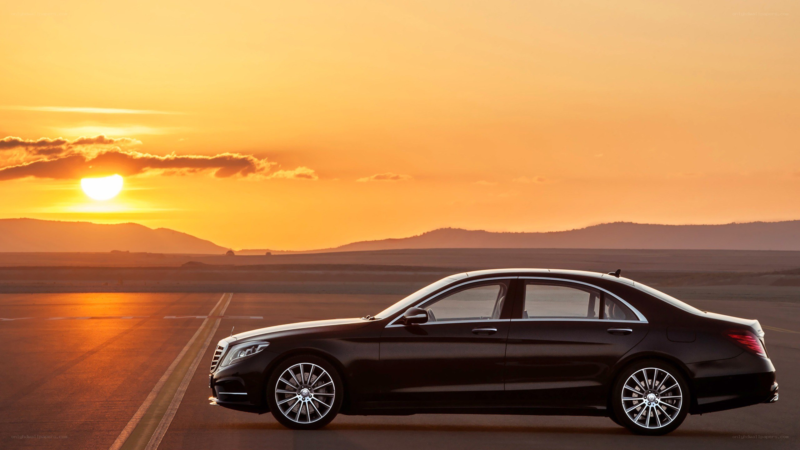 Black sedan at sunset