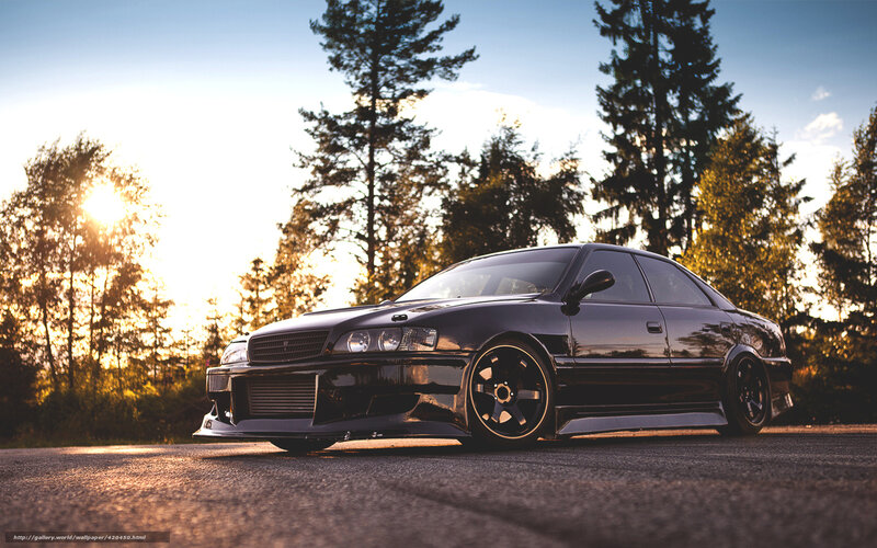 Black sedan at sunset