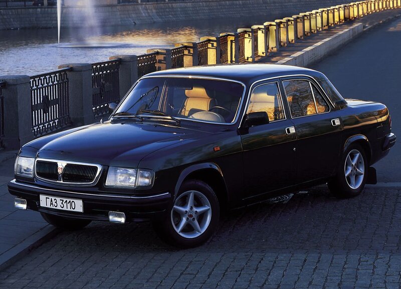 Black sedan by a river
