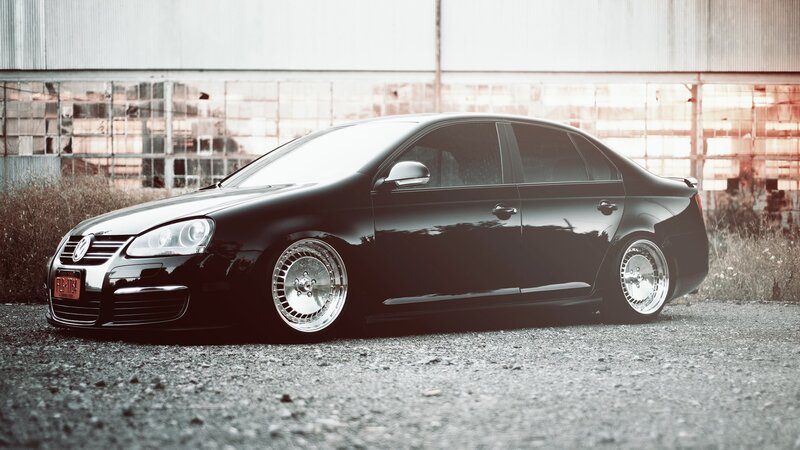 Black Sedan Car — Dramatic, Afternoon, Photograph, Gravel, Building