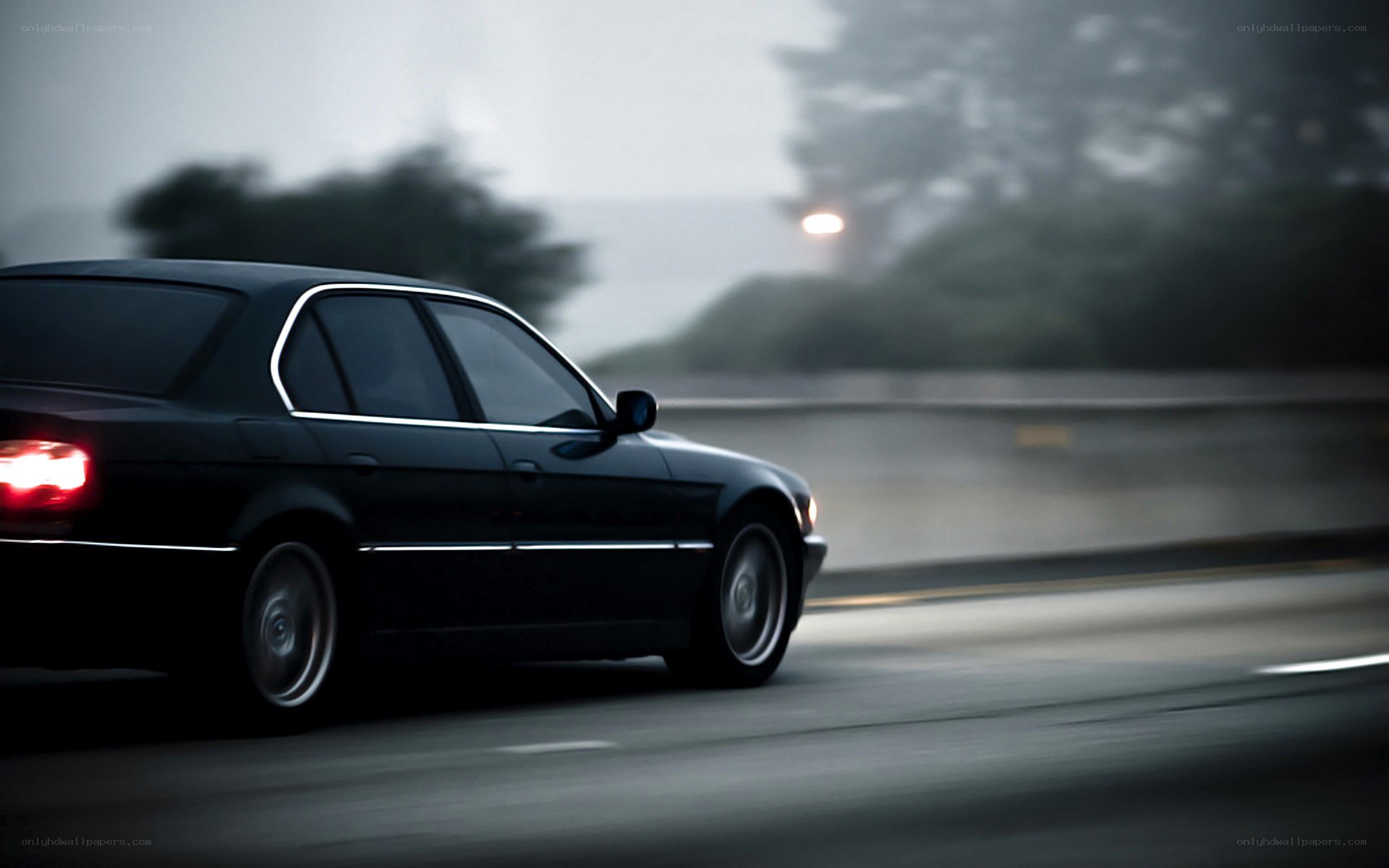 black sedan driving at night