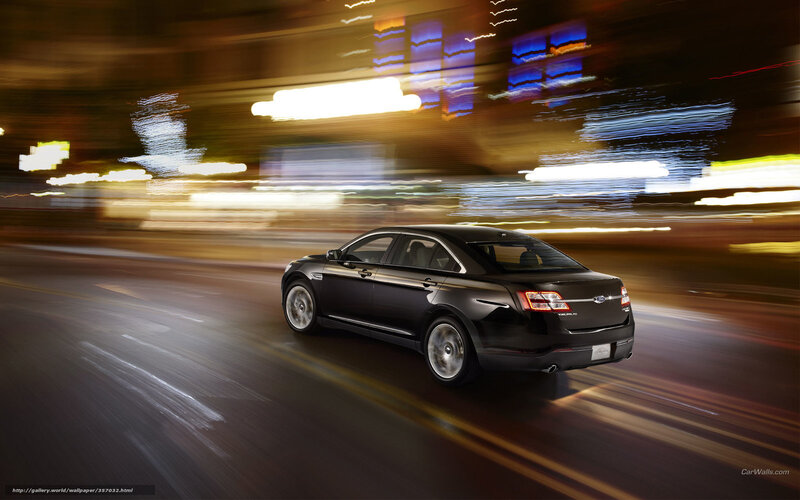 Black sedan driving at night